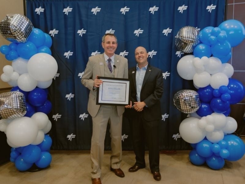 Employee accepting award from CEO
