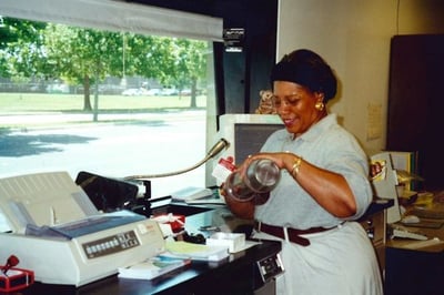 Historical photo of employee in the drive-thru
