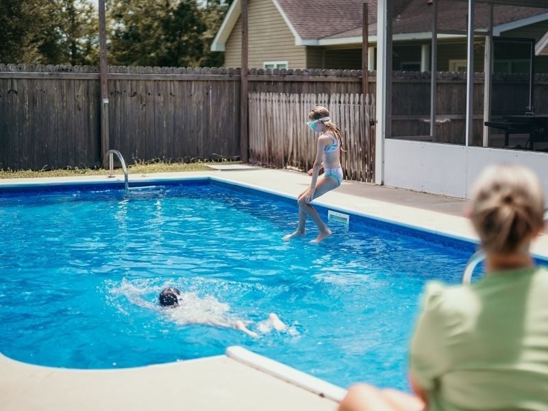 Kids jumping into pool