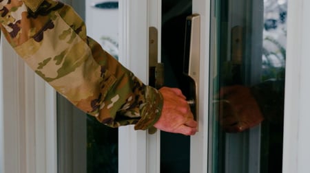 Military person opening door