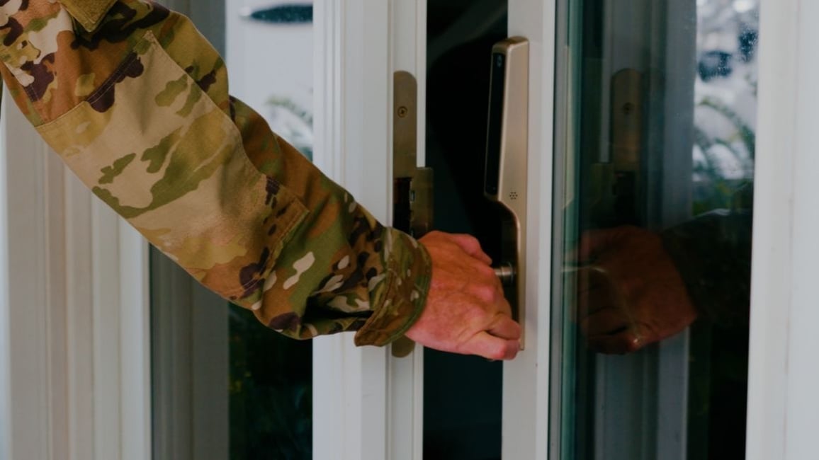 Military person opening door