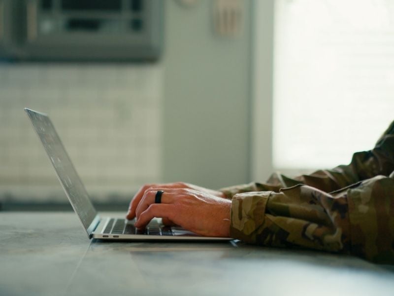 Military person searching on laptop