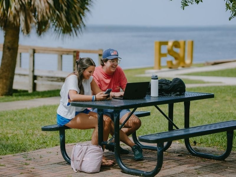 Students on phone and laptop