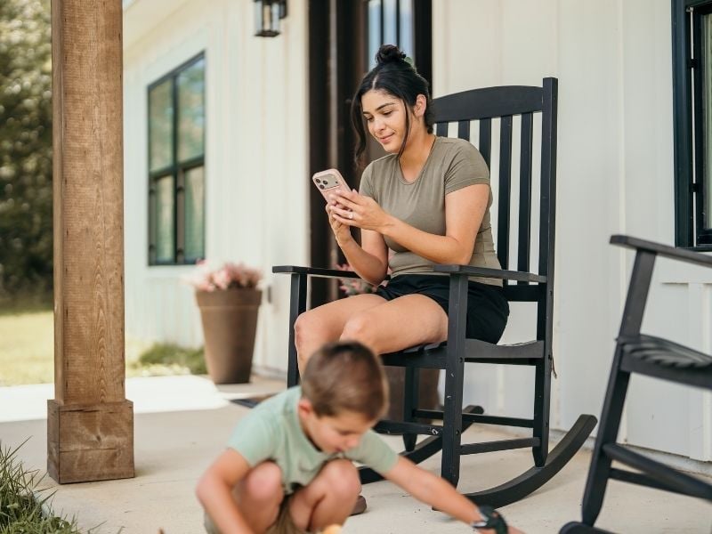 Woman and child on porch of home