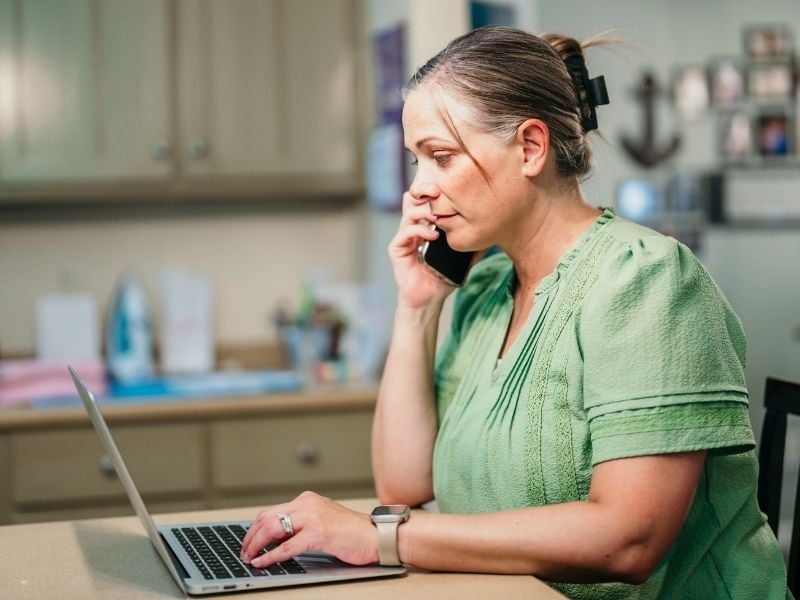 Woman on phone and laptop