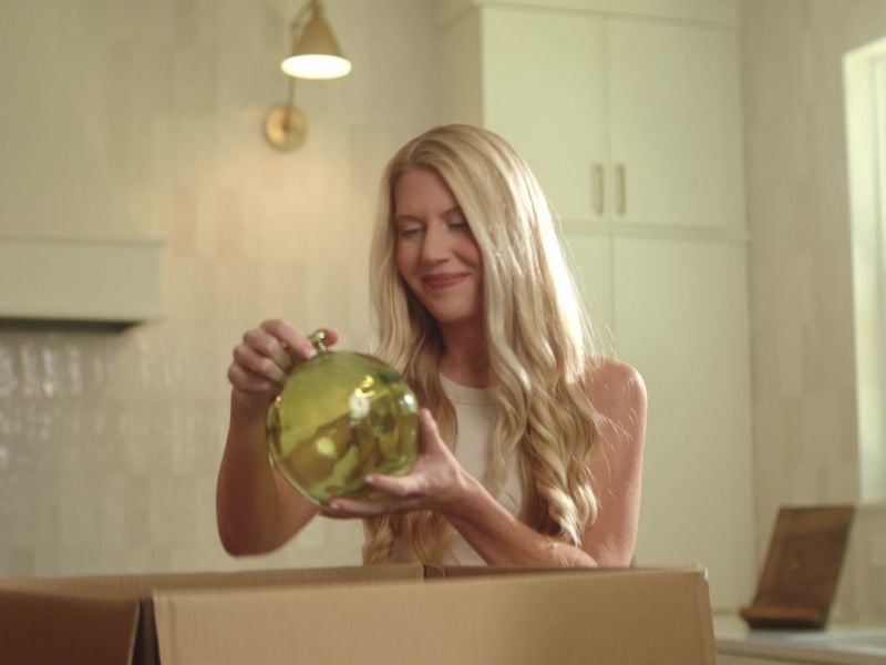 Woman unboxing decor in new home