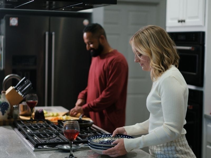 Young couple making dinner in kitchen
