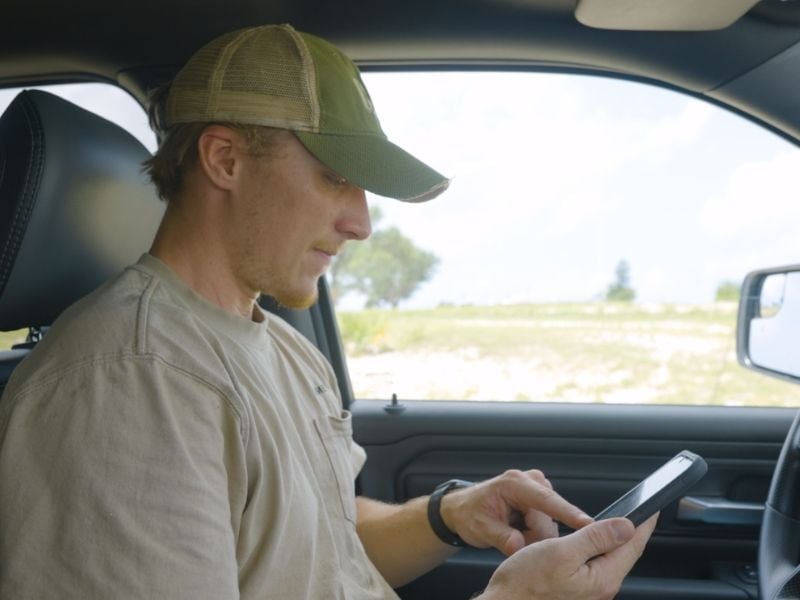 Young man in car on phone